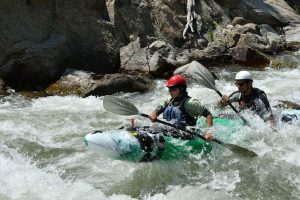 Stacy Gold and husband maintaining balance in their tandem whitewater kayak